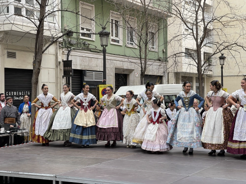 “Woman in traditional valencian dress standing on a stage next to each other”